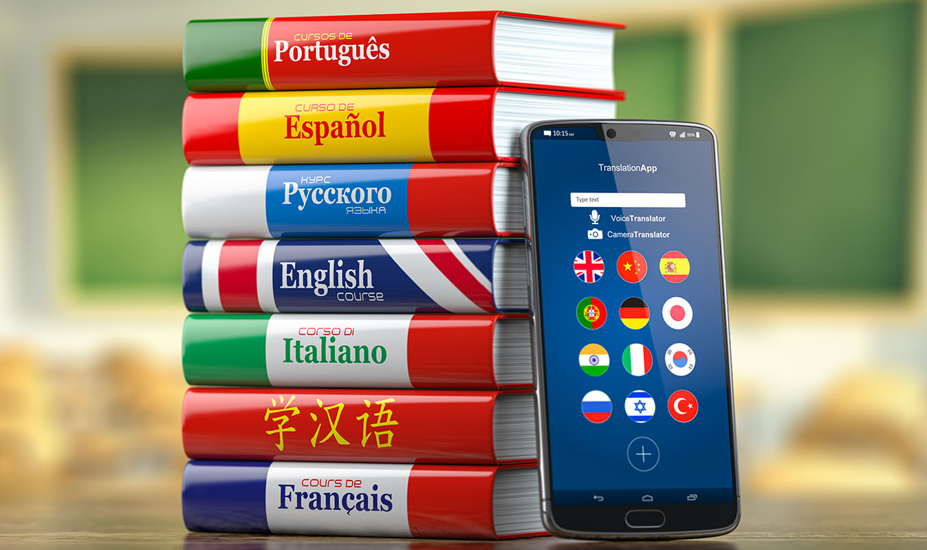 piles of language books with the phone of leanguage learning app standing